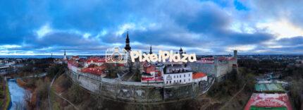 Experience the breathtaking beauty of Tallinn in winter with this stunning aerial panoramic view. Captured by a drone, this image showcases the historic Old Town, its medieval towers, rooftops.